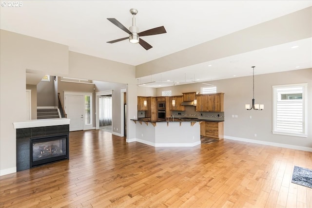 32092 SW Willamette Way E, Wilsonville, OR 97070 - unfurnished living room featuring a ceiling fan, light wood-type flooring, baseboards, a chandelier, and recessed lighting