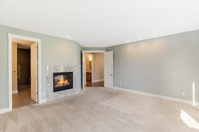 32092 SW Willamette Way E, Wilsonville, OR 97070 - unfurnished living room with carpet flooring, a premium fireplace, baseboards, and recessed lighting