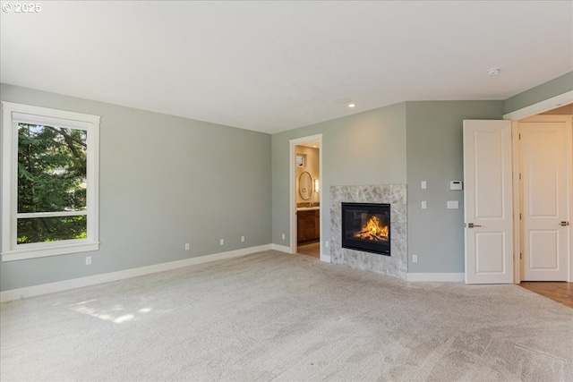 32092 SW Willamette Way E, Wilsonville, OR 97070 - unfurnished living room featuring carpet floors, a premium fireplace, baseboards, and recessed lighting