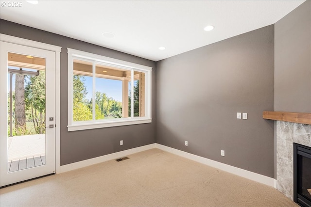 32092 SW Willamette Way E, Wilsonville, OR 97070 - unfurnished living room featuring carpet, a fireplace, baseboards, and recessed lighting