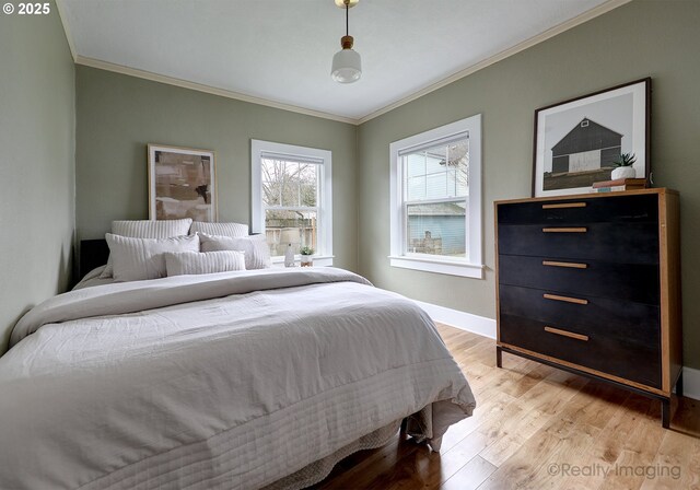 bedroom with light hardwood / wood-style floors and crown molding