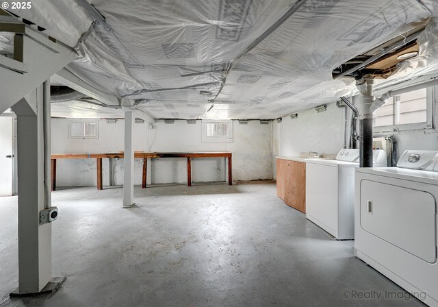 basement with washer and dryer and a healthy amount of sunlight