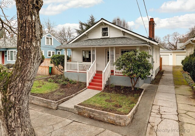 bungalow-style house featuring a garage and covered porch