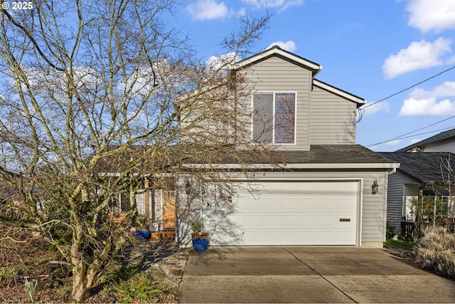 view of front of house with roof with shingles, concrete driveway, and an attached garage