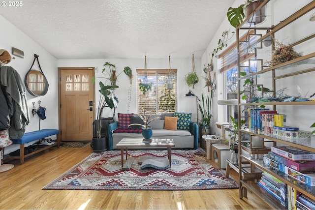 living area with a textured ceiling and wood finished floors