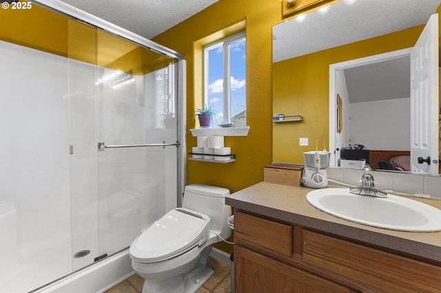 full bath featuring toilet, a stall shower, a textured ceiling, tile patterned flooring, and vanity