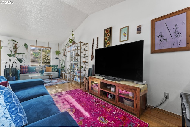 living room with vaulted ceiling, wood finished floors, and a textured ceiling