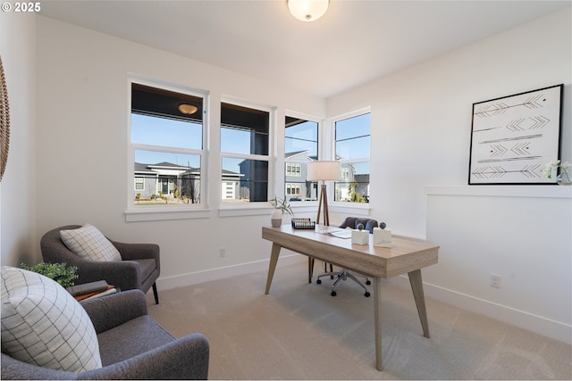 carpeted office featuring baseboards