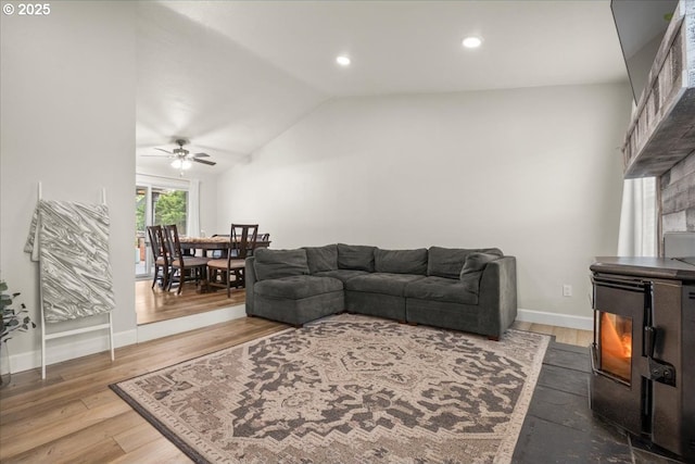 901 SE Olympia Dr, Vancouver, WA 98683 - living room with wood finished floors, ceiling fan, a lit fireplace, and vaulted ceiling