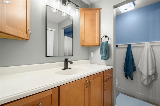 901 SE Olympia Dr, Vancouver, WA 98683 - bathroom with wainscoting, vanity, and toilet