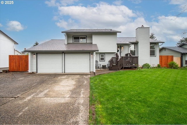 901 SE Olympia Dr, Vancouver, WA 98683 - split level home with fence, a front yard, a chimney, and driveway