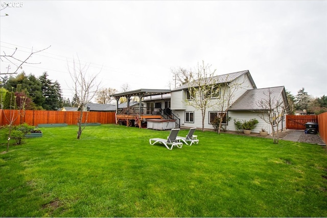 901 SE Olympia Dr, Vancouver, WA 98683 - rear view of house featuring a yard, a hot tub, a deck, and a fenced backyard