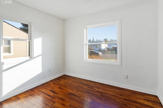 empty room featuring dark hardwood / wood-style floors and a wealth of natural light