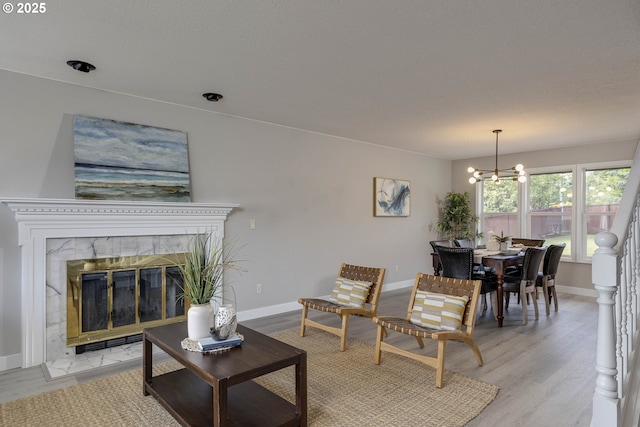 9711 SE Top O Scott St, Happy Valley, OR 97086 - living area featuring a chandelier, light wood-style flooring, and a fireplace