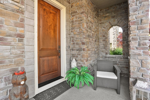 property entrance featuring brick siding