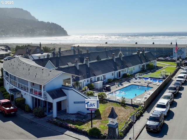 bird's eye view of extended coastline and a pool area