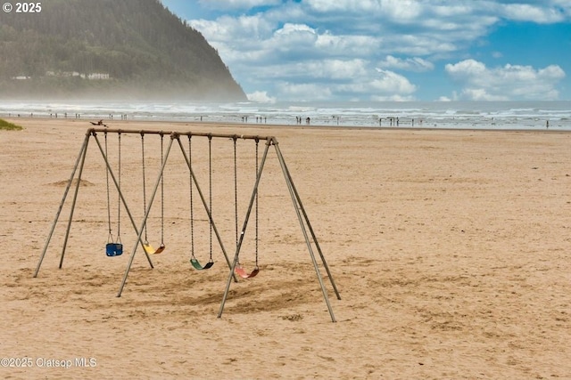 view of home's community with view of water and beach