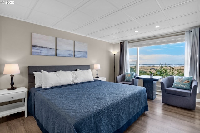 bedroom with recessed lighting and wood finished floors