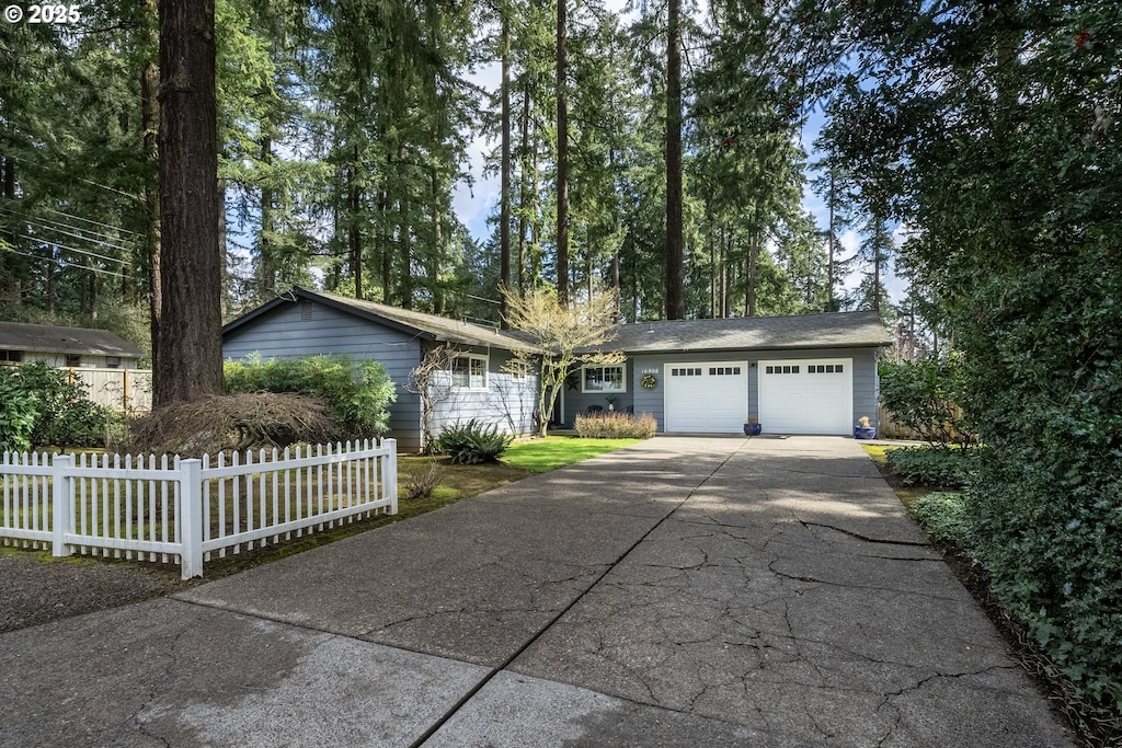 16808 SW Inverurie Rd, Lake Oswego, OR 97035 - ranch-style home with concrete driveway, a garage, and fence