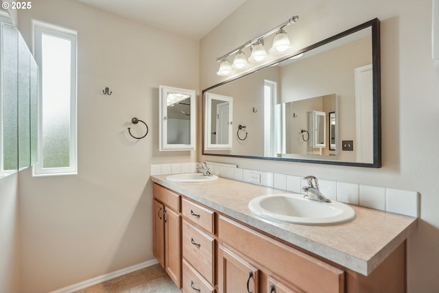 full bathroom with double vanity and baseboards