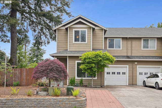 view of front of house featuring fence, driveway, a garage, and a shingled roof