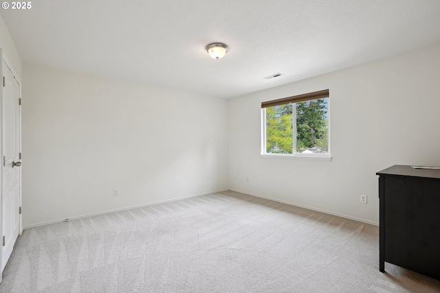unfurnished bedroom with light carpet and baseboards
