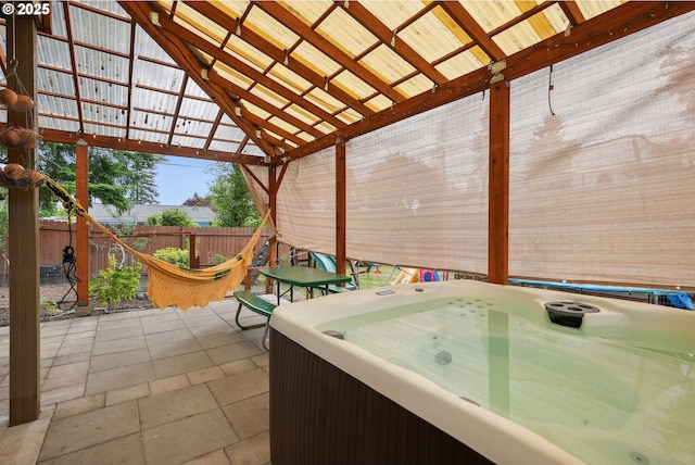 view of patio / terrace with a fenced backyard, a hot tub, and a gazebo