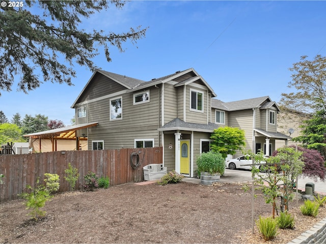 view of front of home with fence and a shingled roof