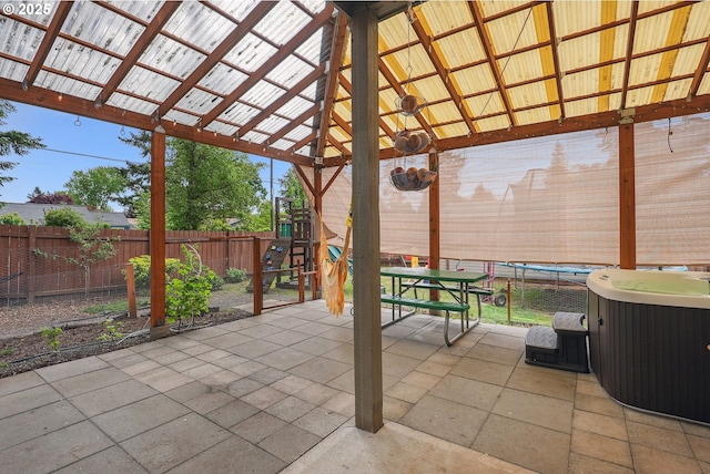 view of patio with a playground, a fenced backyard, a gazebo, and a hot tub
