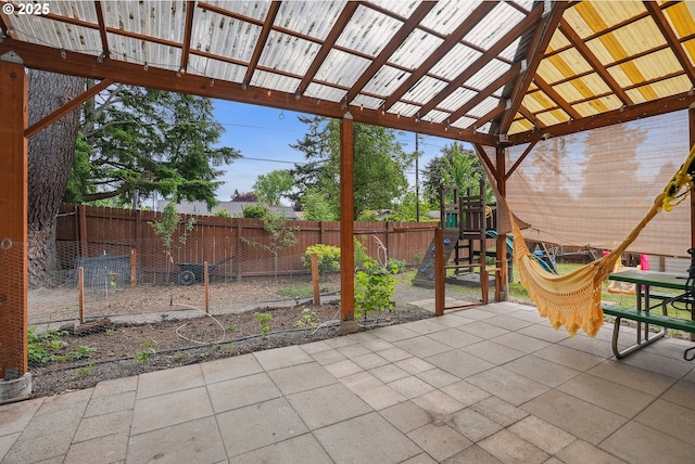 view of patio / terrace featuring a playground and a fenced backyard