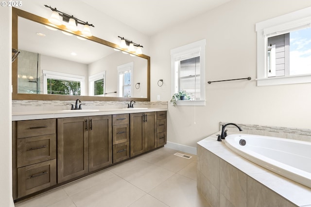 16944 SW Birdsong St, Beaverton, OR 97007 - full bath featuring double vanity, a bath, tile patterned flooring, baseboards, and tiled shower