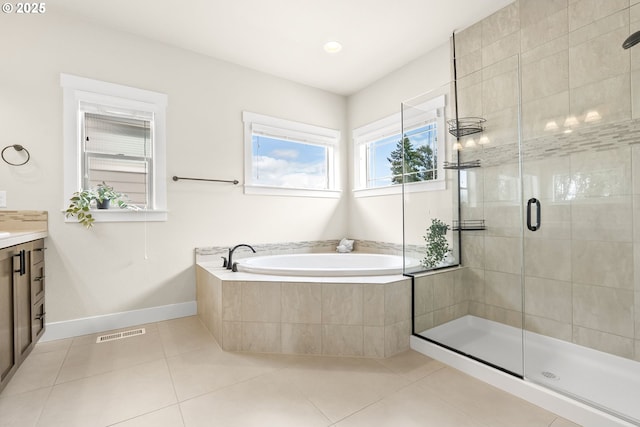 16944 SW Birdsong St, Beaverton, OR 97007 - bathroom with vanity, a bath, a stall shower, tile patterned flooring, and baseboards