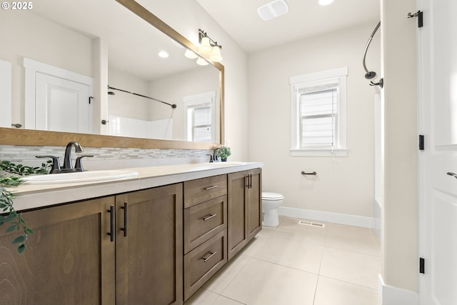 16944 SW Birdsong St, Beaverton, OR 97007 - full bathroom with double vanity, shower / bath combination, baseboards, tile patterned flooring, and toilet