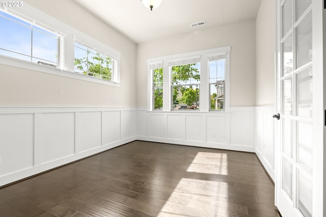 16944 SW Birdsong St, Beaverton, OR 97007 - empty room with a decorative wall, wainscoting, and dark wood-style flooring