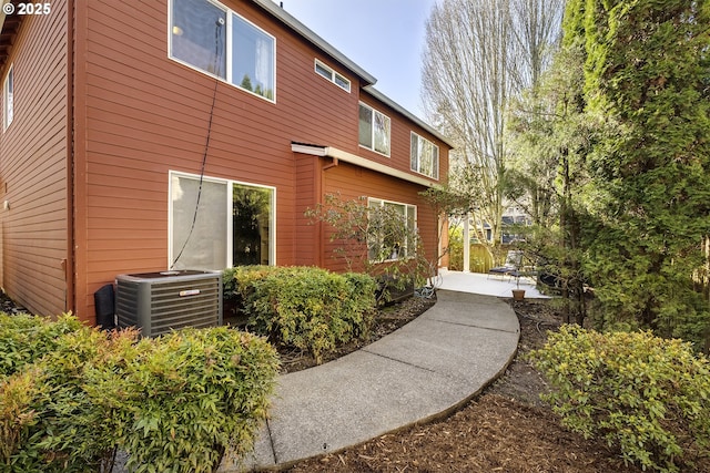 exterior space with central AC and a patio