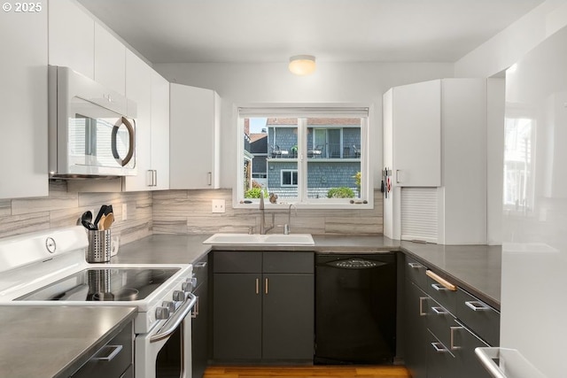 530 N Hayden Bay Dr, Portland, OR 97217 - kitchen with white appliances, a sink, white cabinetry, and decorative backsplash