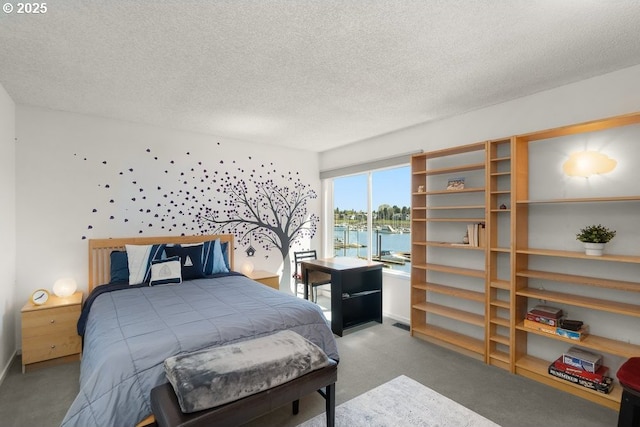 530 N Hayden Bay Dr, Portland, OR 97217 - bedroom featuring carpet flooring, a textured ceiling, and a water view