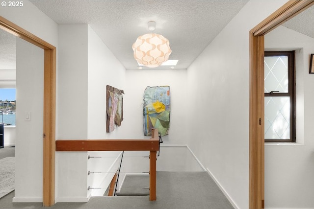 530 N Hayden Bay Dr, Portland, OR 97217 - hall with carpet floors, a textured ceiling, and baseboards
