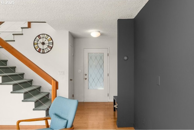530 N Hayden Bay Dr, Portland, OR 97217 - foyer featuring wood finished floors, a textured ceiling, and stairway