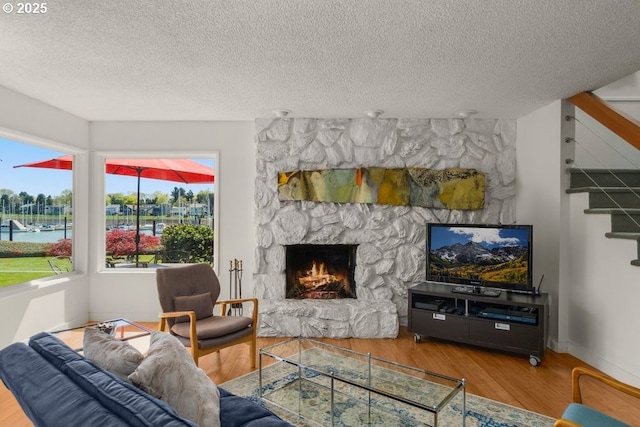 530 N Hayden Bay Dr, Portland, OR 97217 - living area with a textured ceiling, wood finished floors, stairway, a fireplace, and baseboards