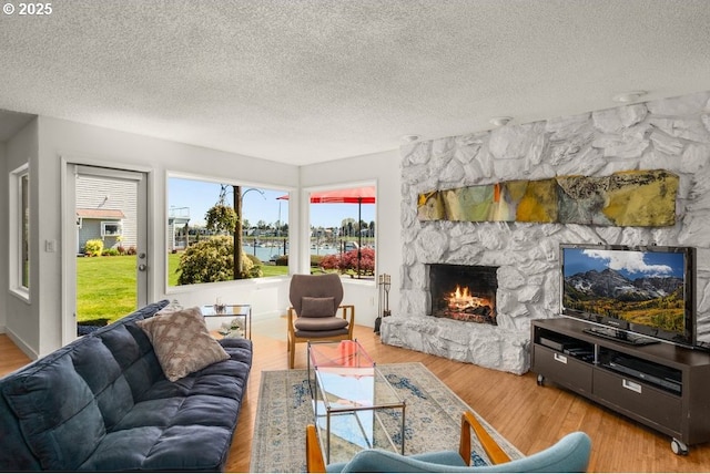 530 N Hayden Bay Dr, Portland, OR 97217 - living area with a textured ceiling, a fireplace, and wood finished floors