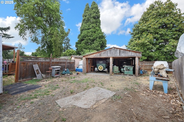 945 Irving Ct, Eugene, OR 97404 - fenced backyard featuring an outdoor structure, a detached garage, and a pole building