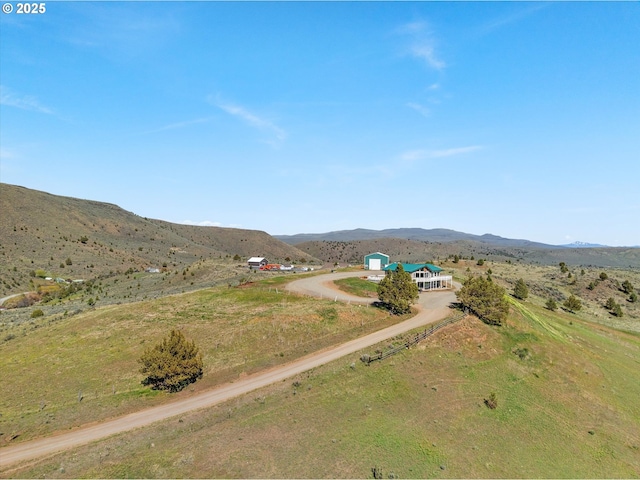drone / aerial view featuring a rural view and a mountain view