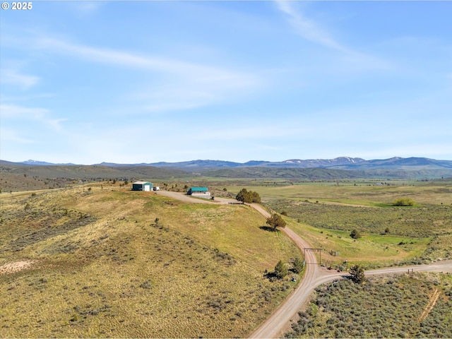 drone / aerial view featuring a rural view and a mountain view