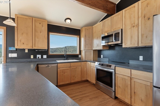 kitchen featuring a sink, stainless steel appliances, light brown cabinetry, dark countertops, and vaulted ceiling with beams