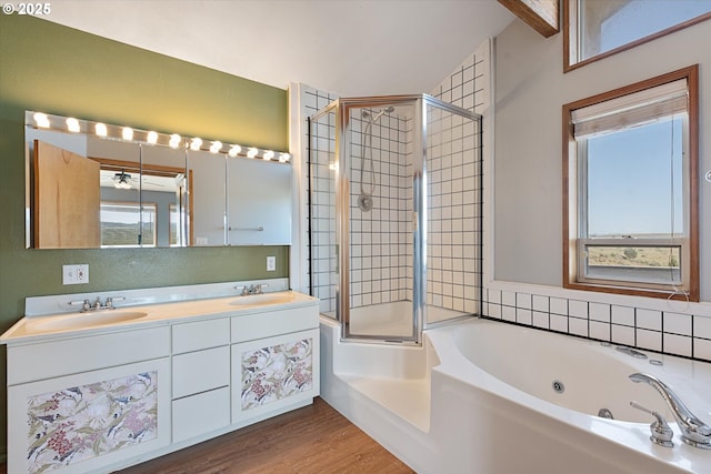 bathroom with a tile shower, wood finished floors, a sink, and a whirlpool tub