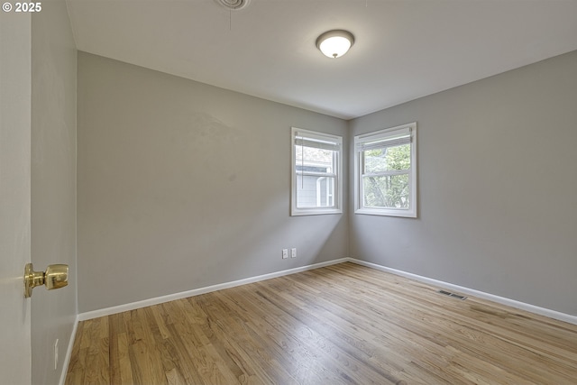unfurnished room with wood finished floors and baseboards