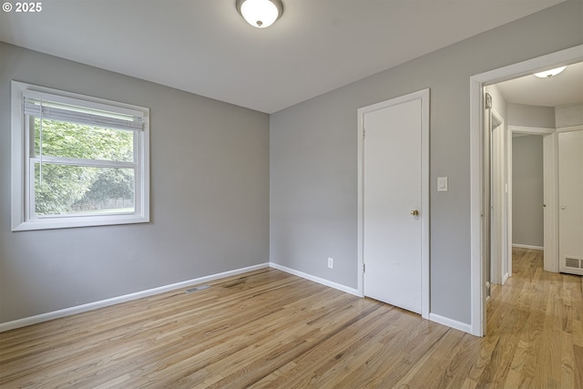 unfurnished bedroom with light wood finished floors and baseboards