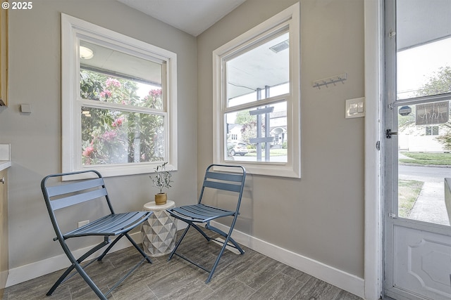 sitting room featuring baseboards and wood finished floors