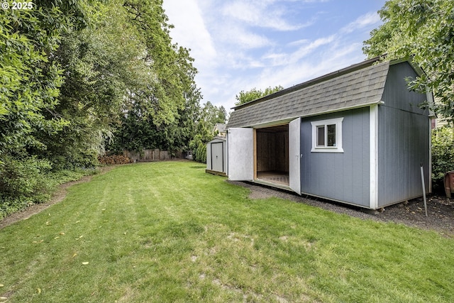 view of yard with a storage shed and an outbuilding
